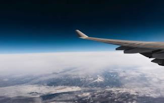 Wing of plane in sky.